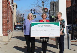 Linda Lorden, President of The Merrimack, presents a check to Nancy Paul (left), Executive Director of the Friends Program, and Kathleen Ames (right), Friends Program Board President.